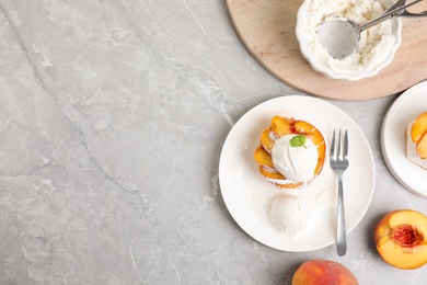 Photo of Delicious peach dessert with ice cream on light marble table, flat lay. Space for text