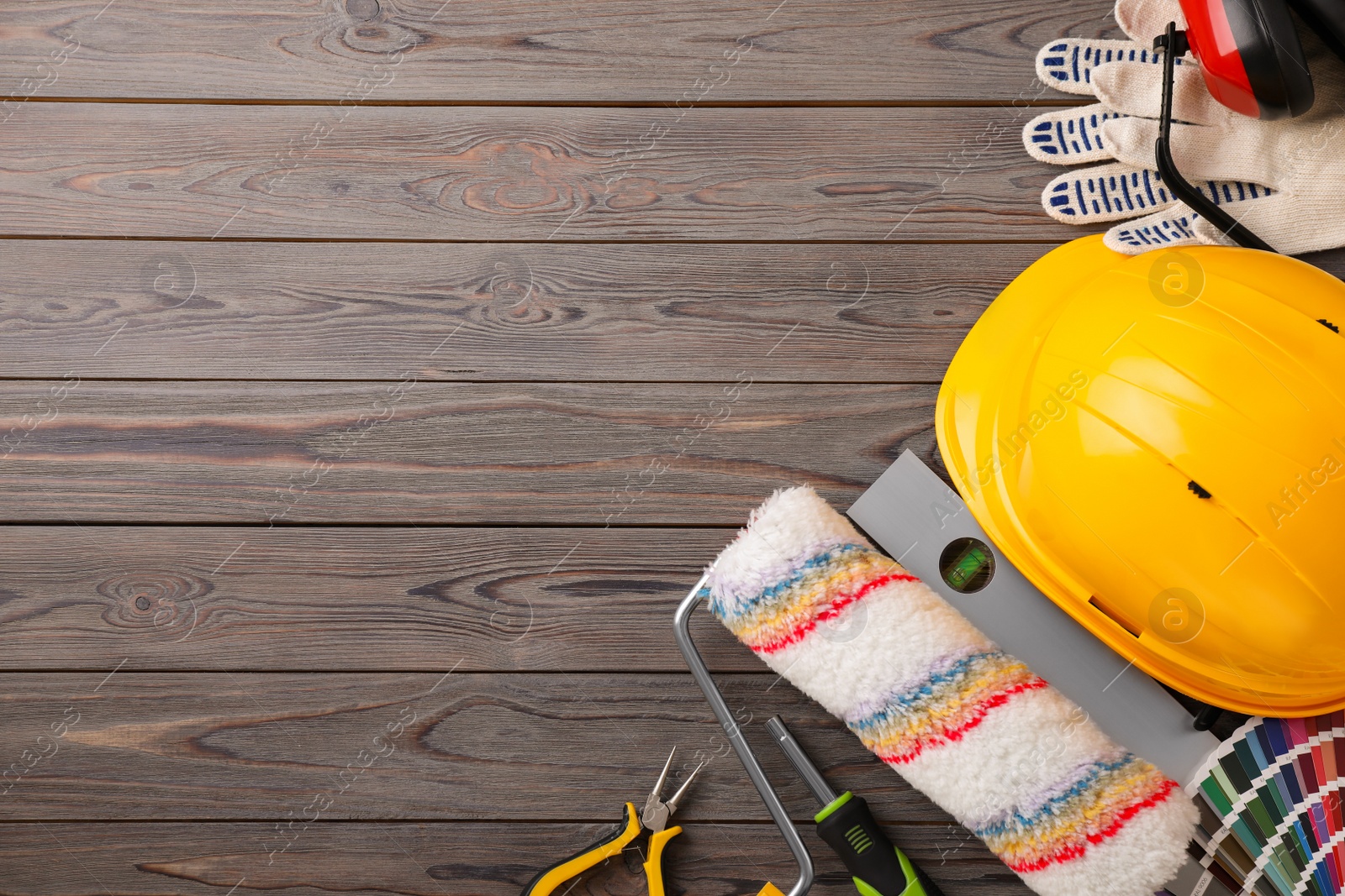 Photo of Flat lay composition with different construction tools on wooden background. Space for text