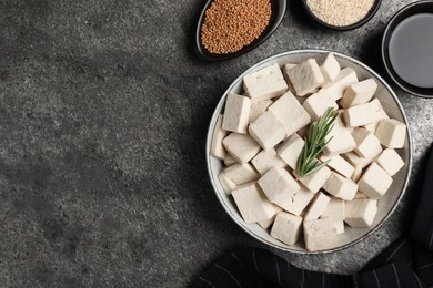 Photo of Delicious tofu with rosemary served on grey table, flat lay. Space for text