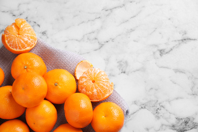 Photo of Fresh ripe tangerines on white marble table, top view. Space for text