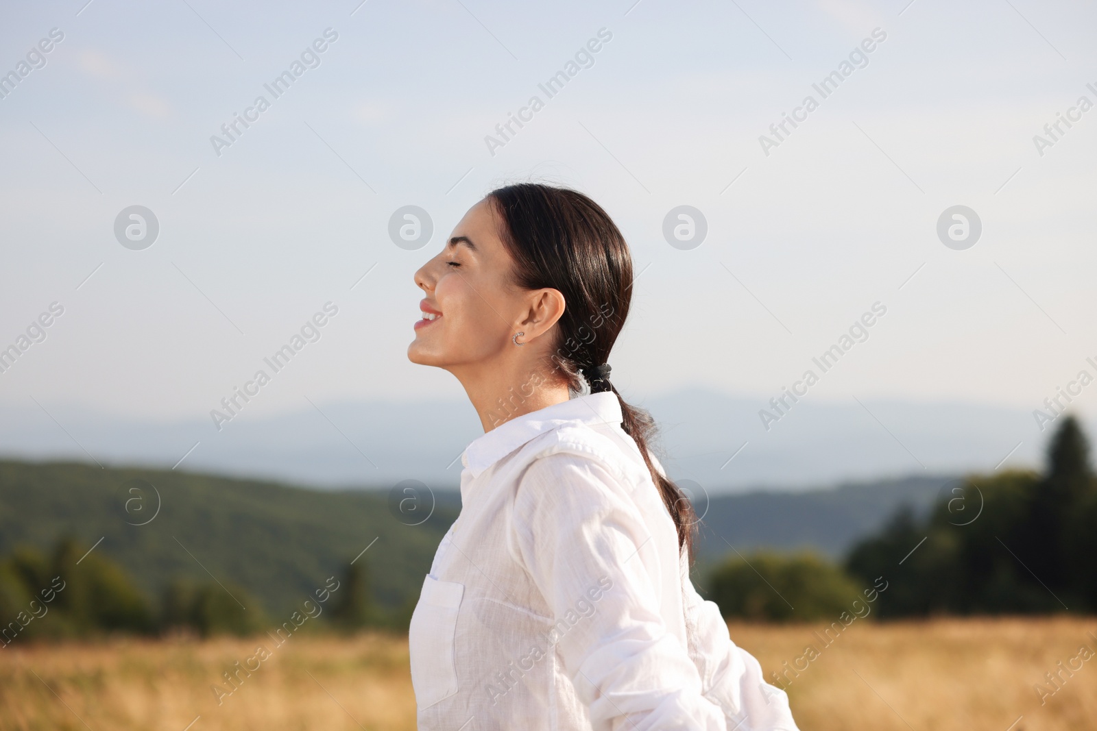 Photo of Feeling freedom. Happy woman enjoying nature outdoors