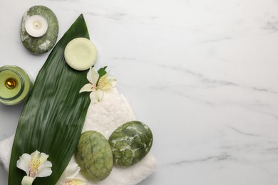 Photo of Flat lay composition with spa products and flowers on white marble table. Space for text