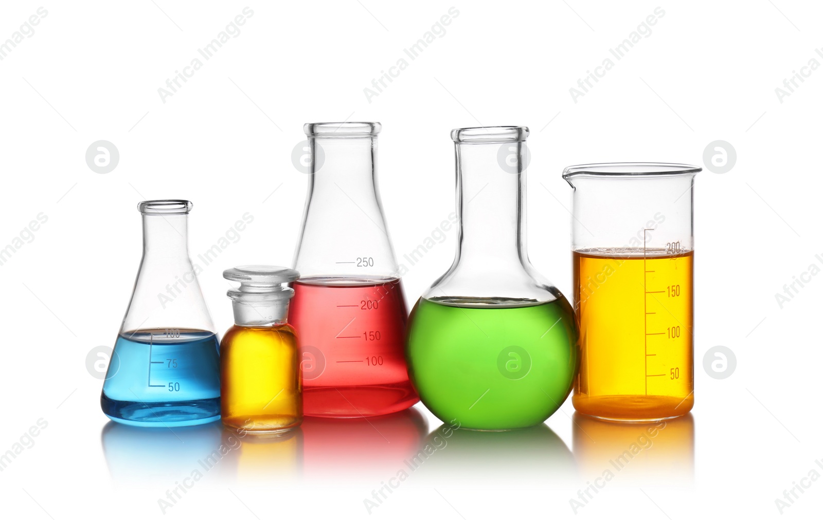 Photo of Set of lab glassware with color liquids isolated on white. Solution chemistry