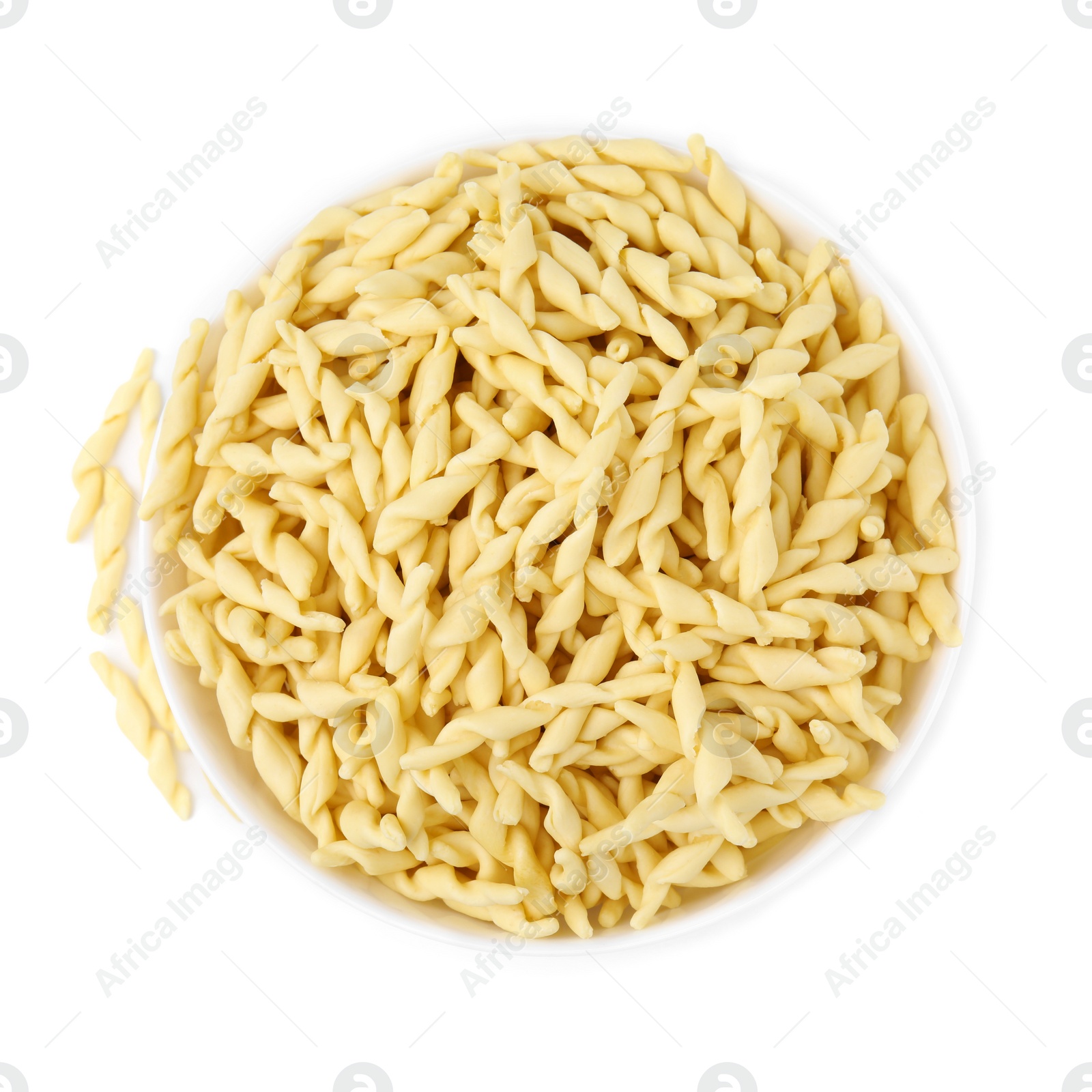 Photo of Bowl with uncooked trofie pasta isolated on white, top view