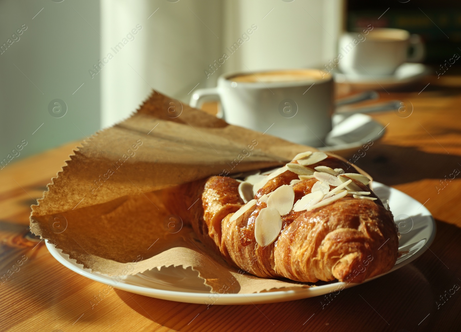 Photo of Woman with cup of fresh aromatic coffee at table in cafe