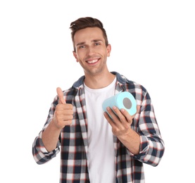Photo of Young man holding toilet paper roll on white background