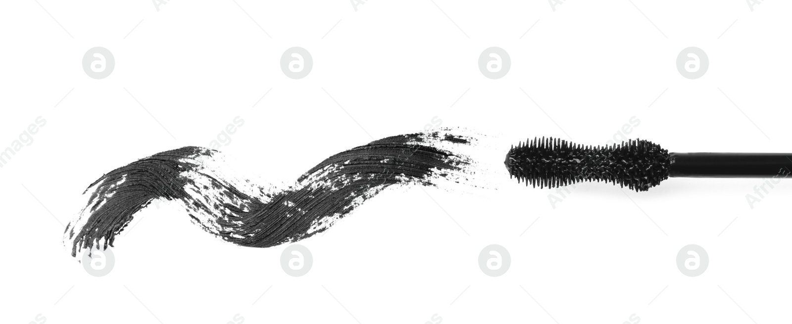 Photo of Applicator and black mascara smear for eyelashes on white background, top view