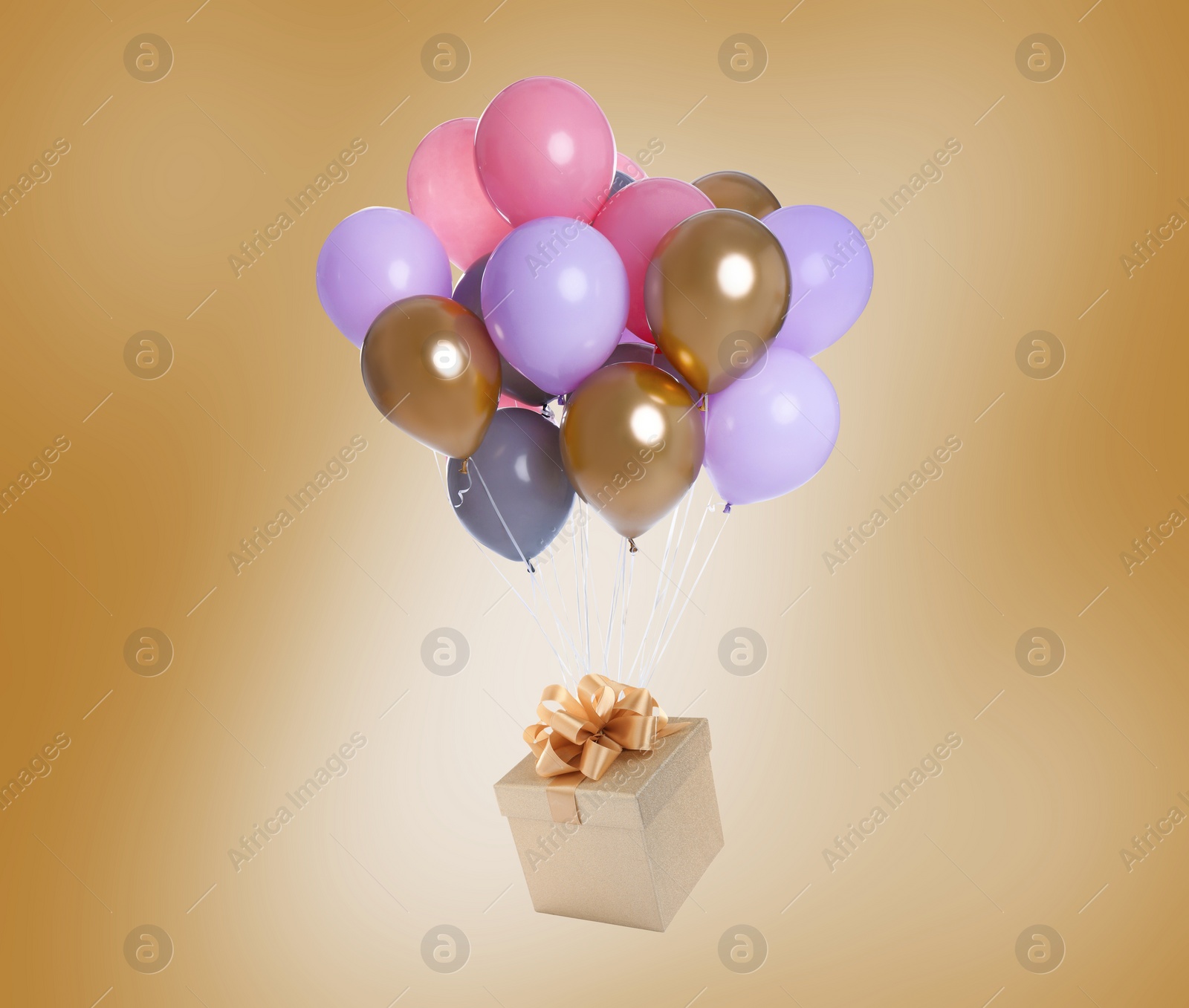 Image of Many balloons tied to gift box on golden background