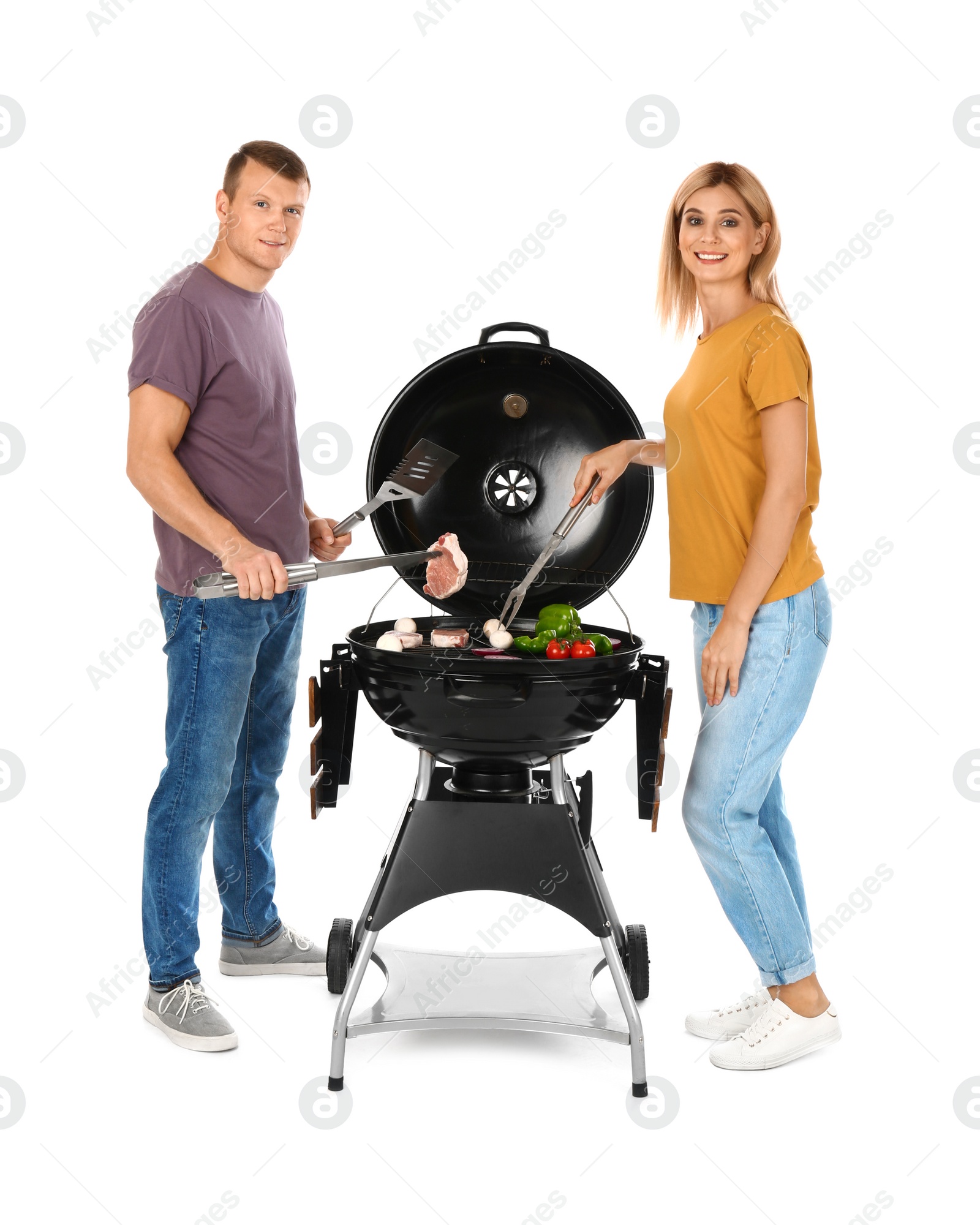 Photo of Happy couple cooking on barbecue grill, white background