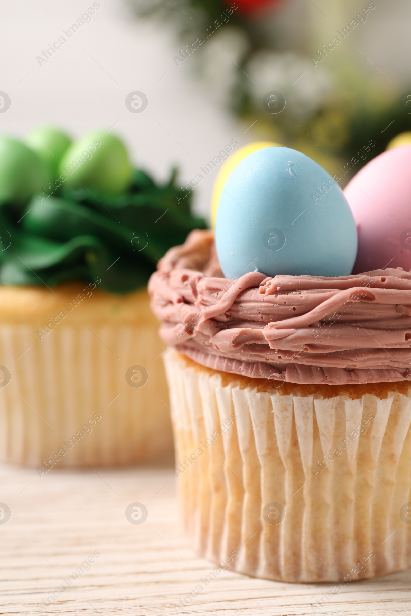 Photo of Tasty decorated Easter cupcakes on table, closeup