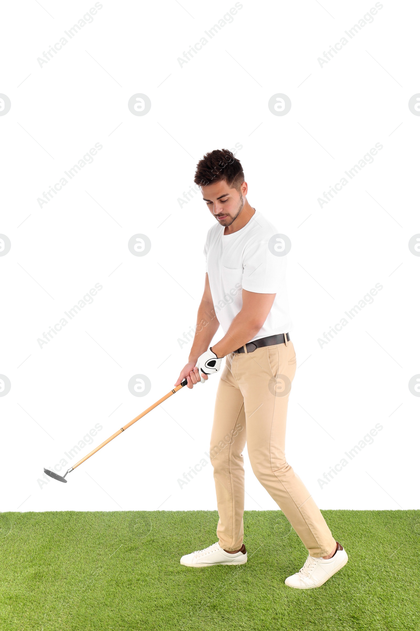 Photo of Young man playing golf on course against white background