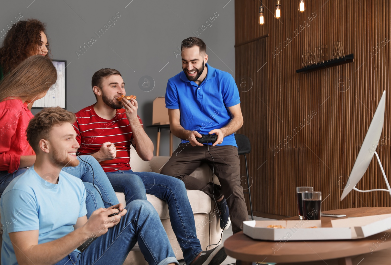 Photo of Emotional friends playing video games at home