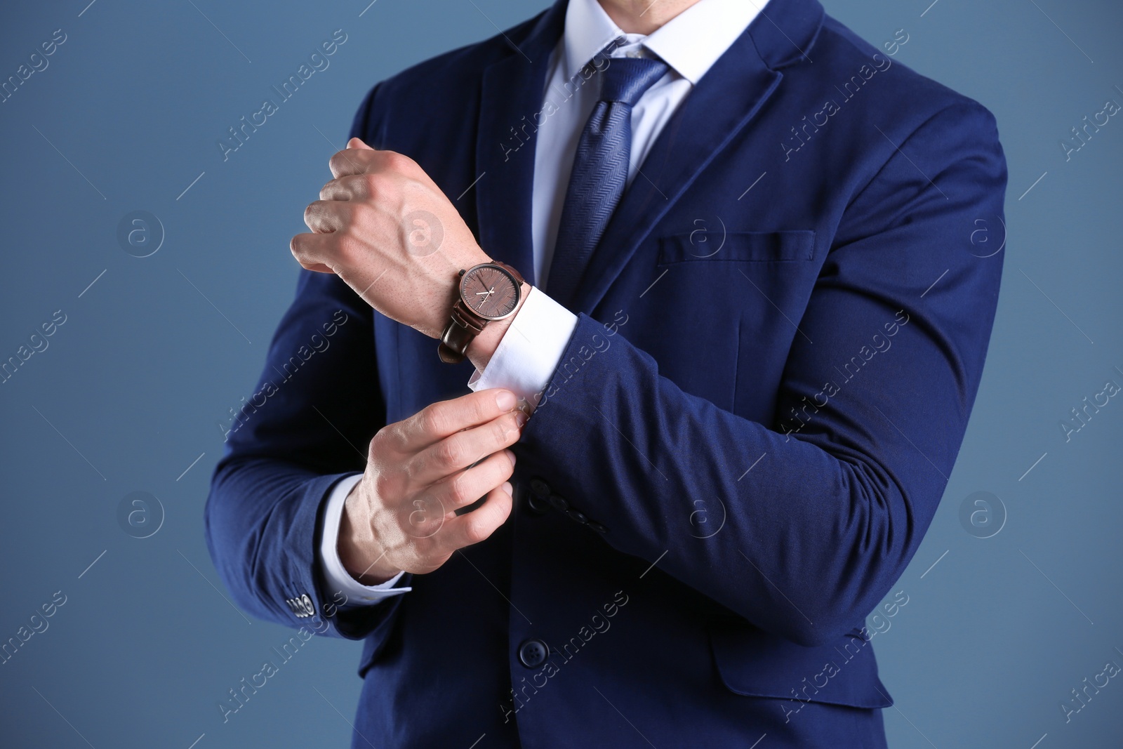 Photo of Businessman with wristwatch on color background. Time concept