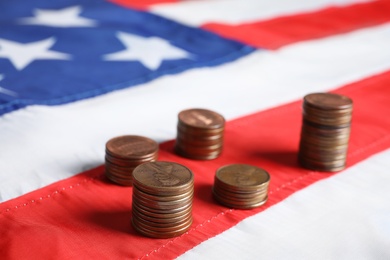 Different stacks of coins on national USA flag