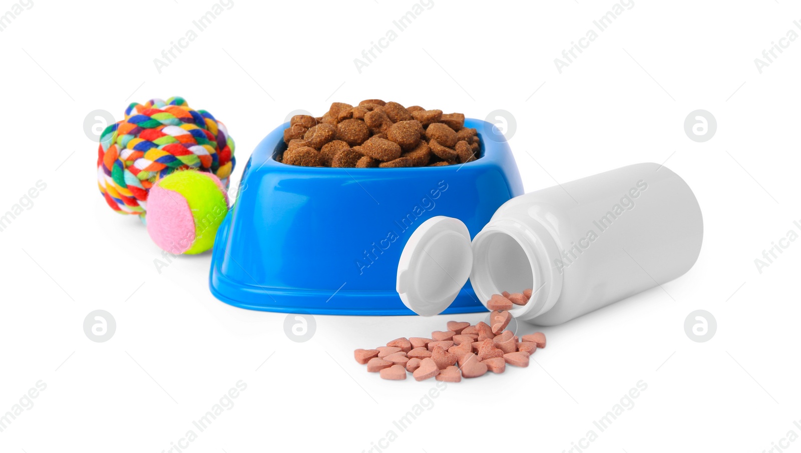 Photo of Dry pet food in bowl, vitamins and toys isolated on white