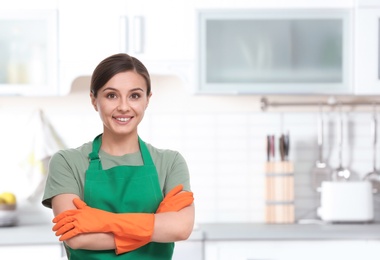 Female worker of cleaning service in uniform indoors