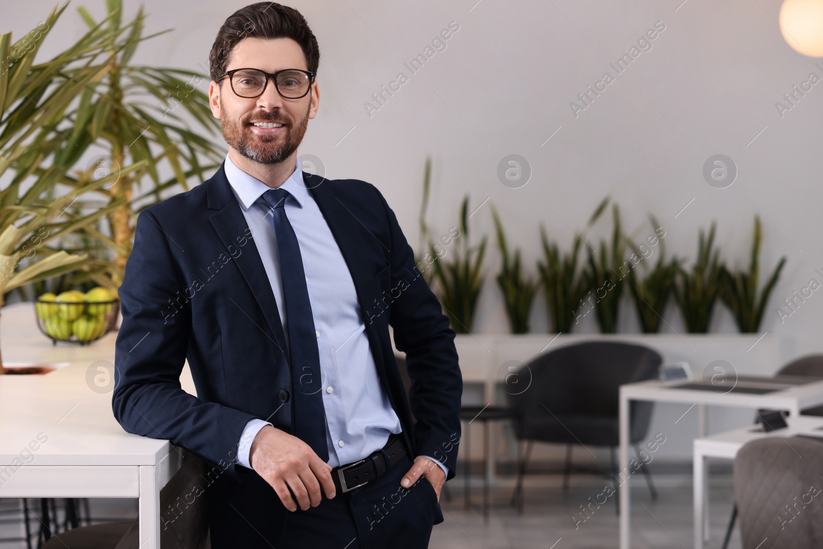 Photo of Happy real estate agent indoors. Space for text