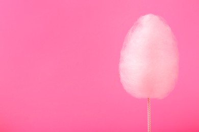 Photo of One sweet cotton candy on pink background, space for text