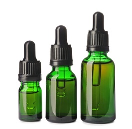 Photo of Cosmetic bottles of essential oils on white background