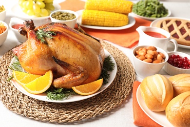 Delicious roasted turkey with garnish on dinner table