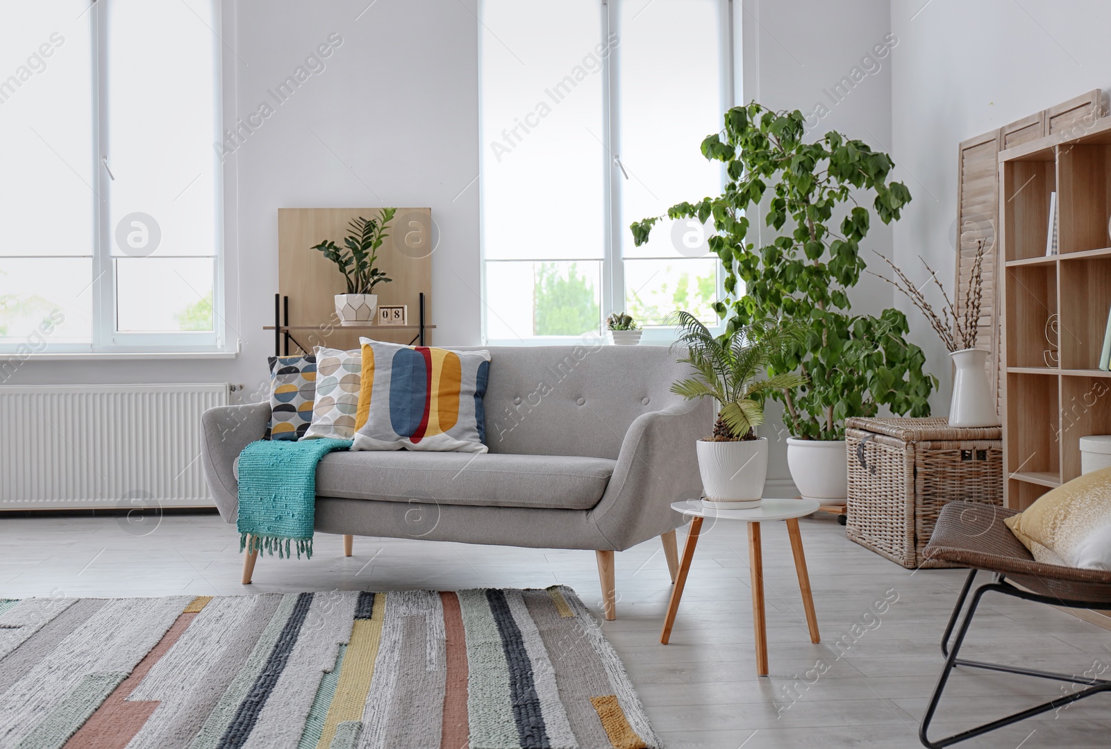 Photo of Elegant living room interior with comfortable sofa and striped carpet