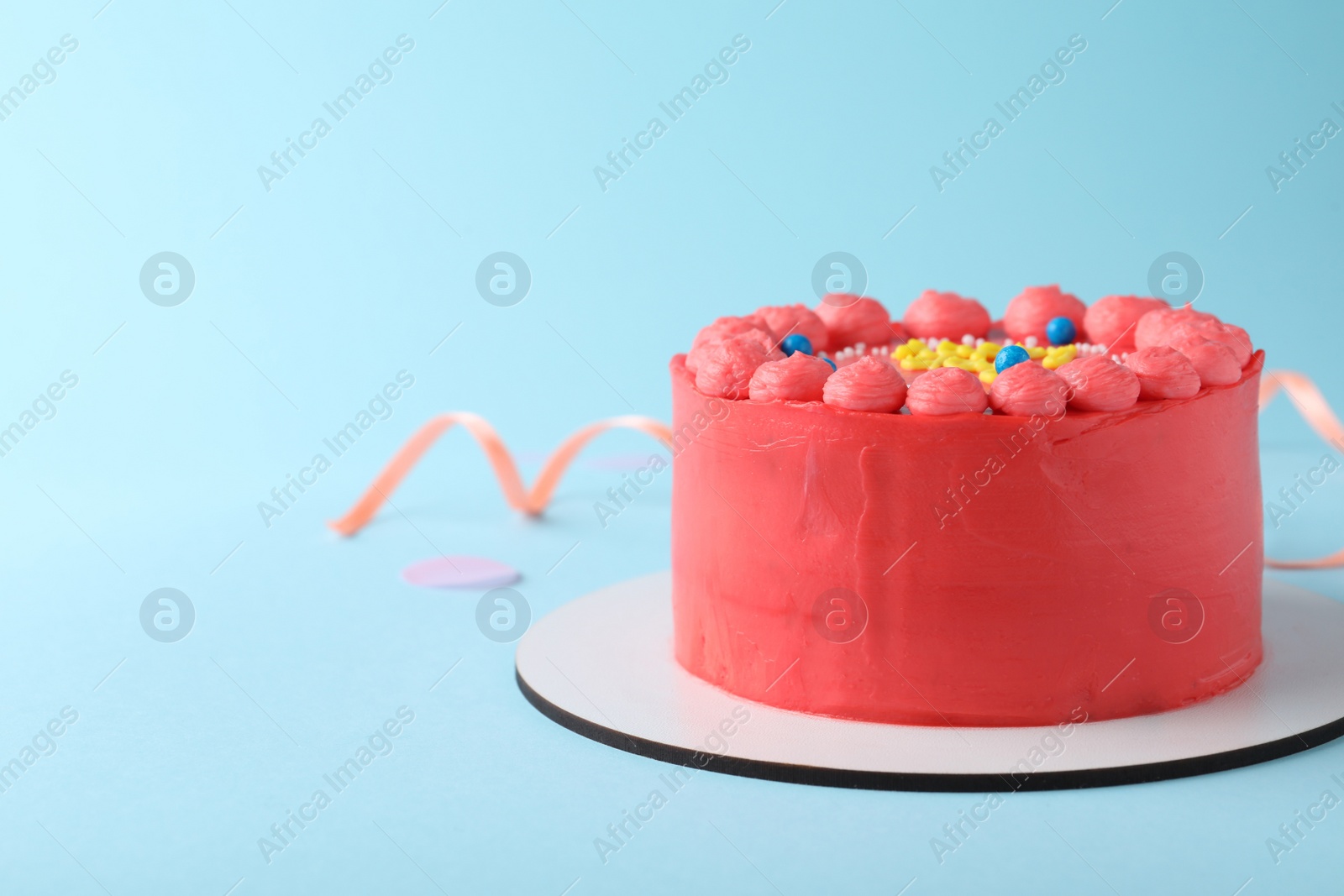 Photo of Cute bento cake with tasty cream on light blue background, space for text