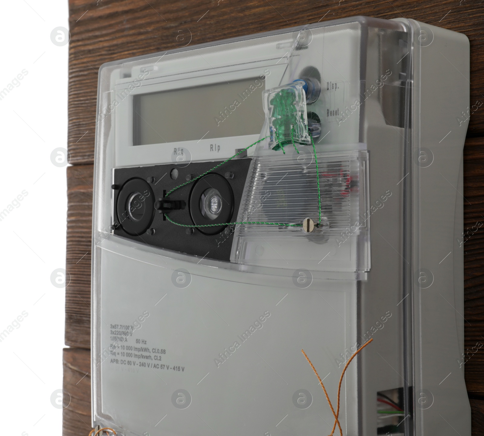 Photo of Electricity meter on wooden wall against white background, closeup. Space for text