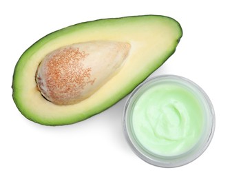 Jar of body cream with avocado on white background, top view