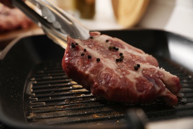 Photo of Frying pan with fresh raw meat, closeup