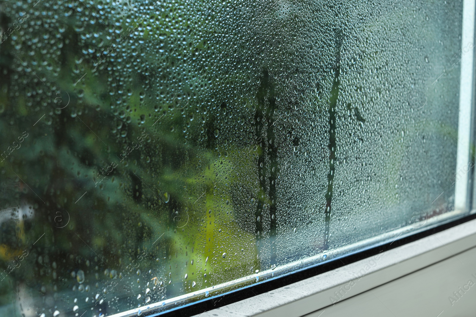 Photo of Window glass with water drops, closeup. Condensation