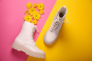 Photo of Pair of stylish leather shoes with flowers on color background, flat lay