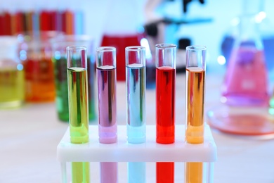 Test tubes with samples in rack on table. Solution chemistry