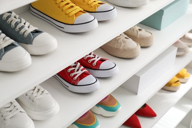 Photo of White shelving unit with collection of colorful sneakers