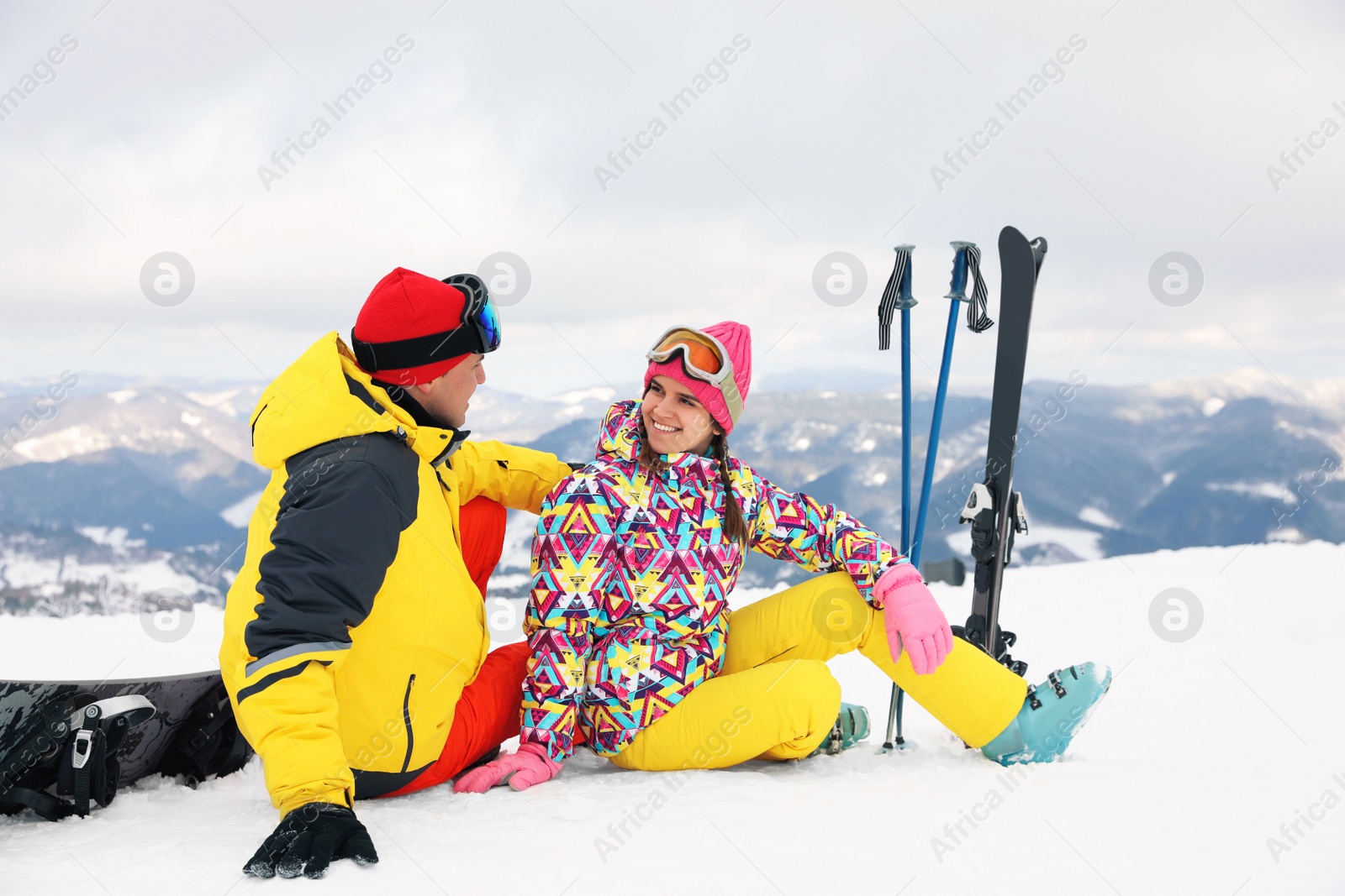 Photo of Lovely couple with equipment at ski resort. Winter vacation