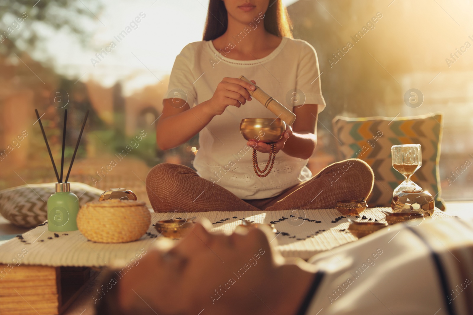 Photo of Man at healing session with singing bowl indoors