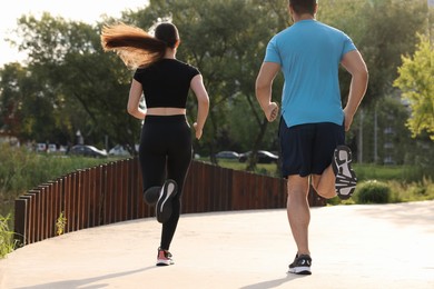 Healthy lifestyle. Couple running outdoors, back view