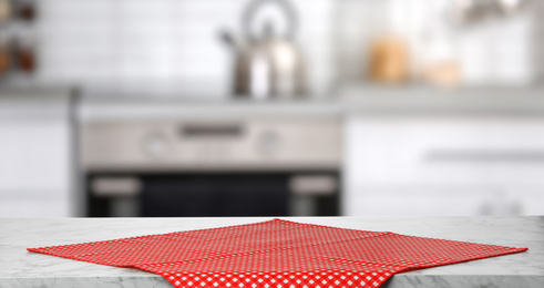 Image of Red towel on marble table in kitchen, space for text. Banner design
