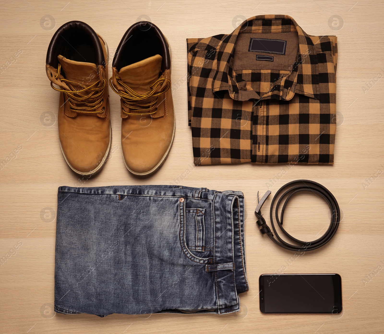 Photo of Flat lay composition with stylish clothes and accessories on wooden background