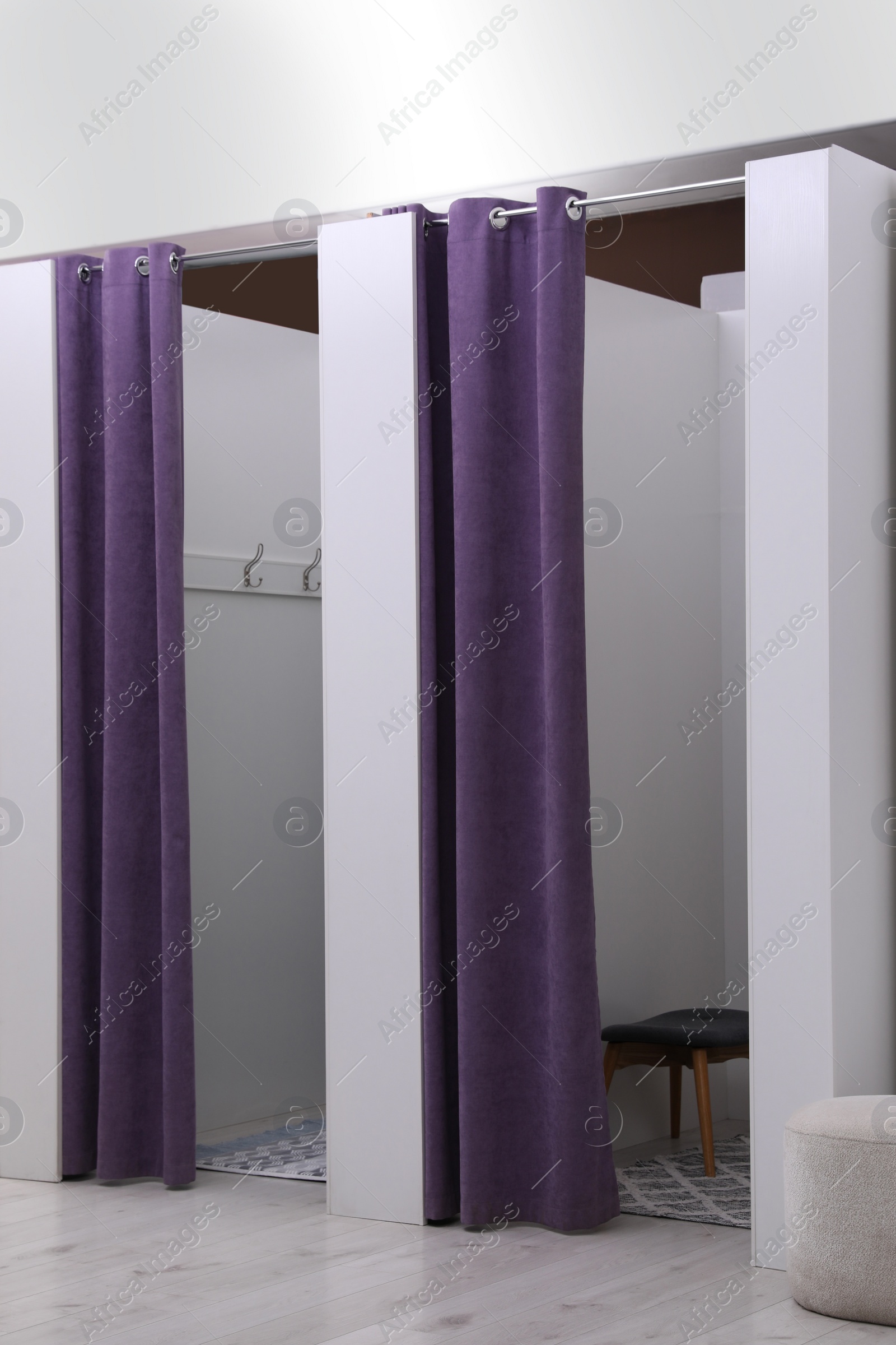 Photo of Empty dressing rooms in fashion store. Stylish interior