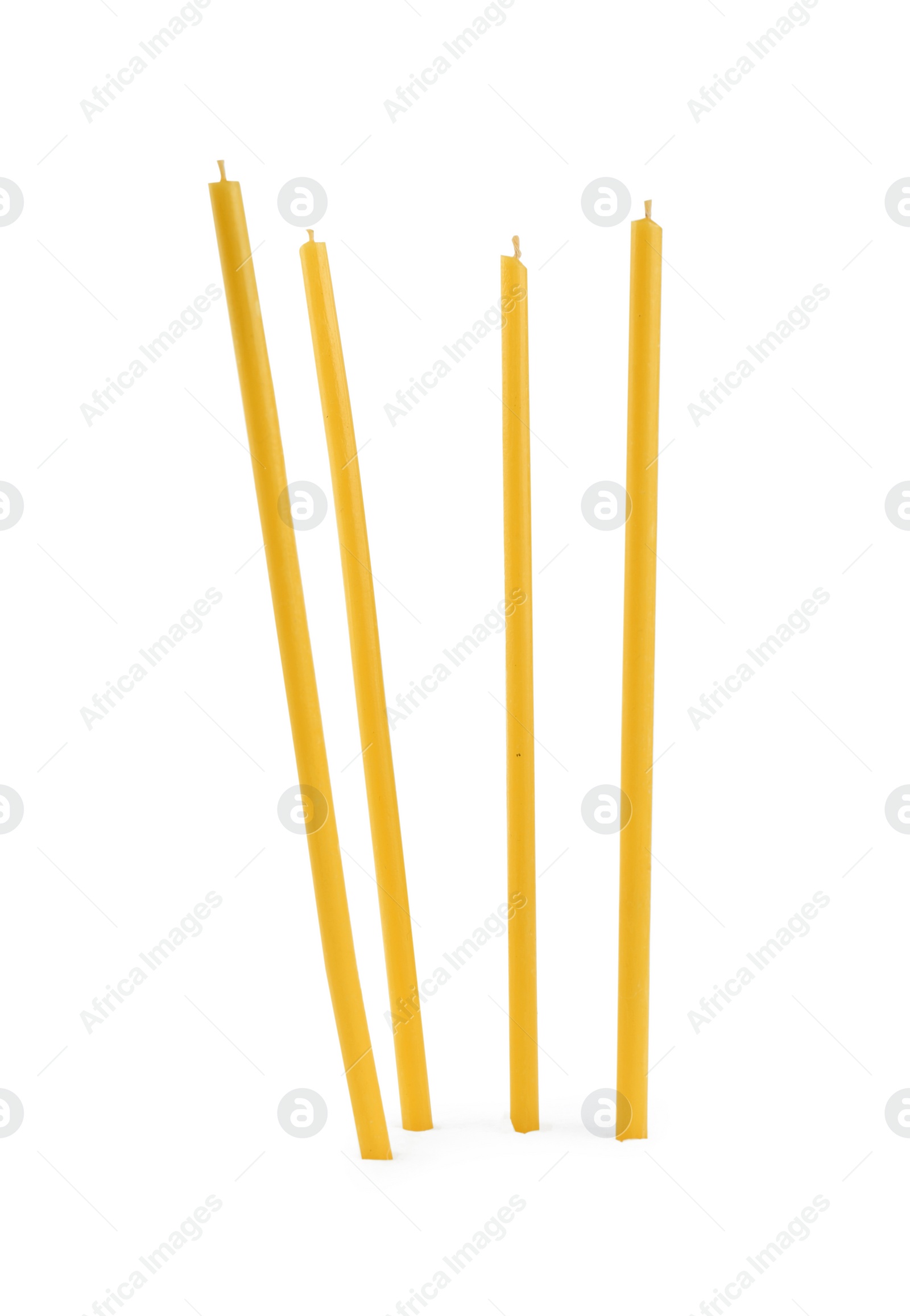 Photo of Many new church candles on white background