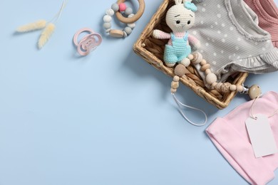 Flat lay composition with different baby accessories on light blue background, space for text