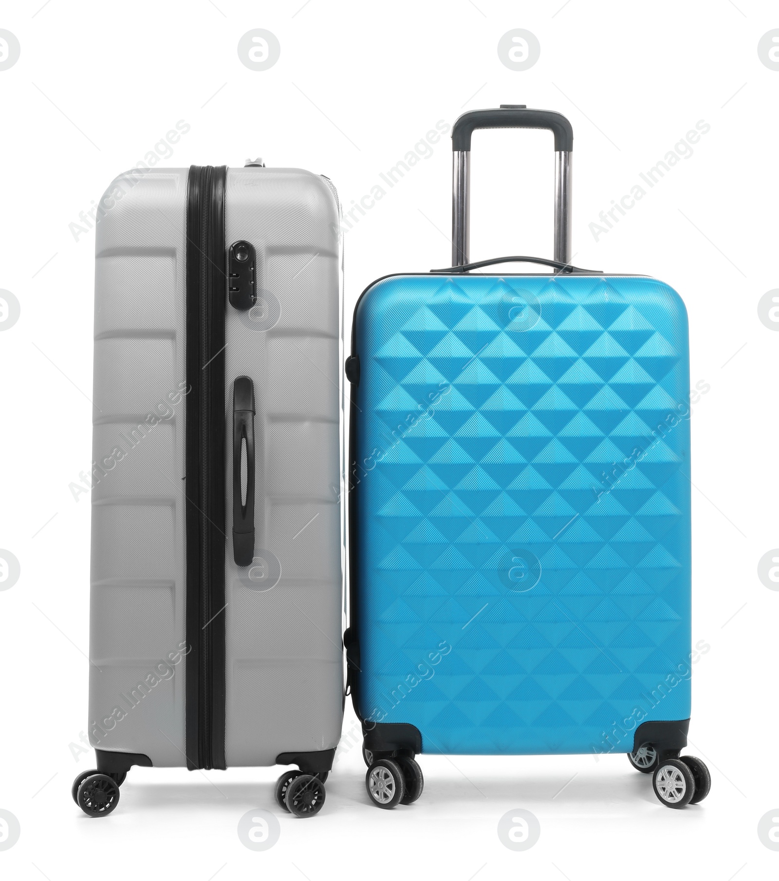 Photo of New suitcases packed for journey on white background