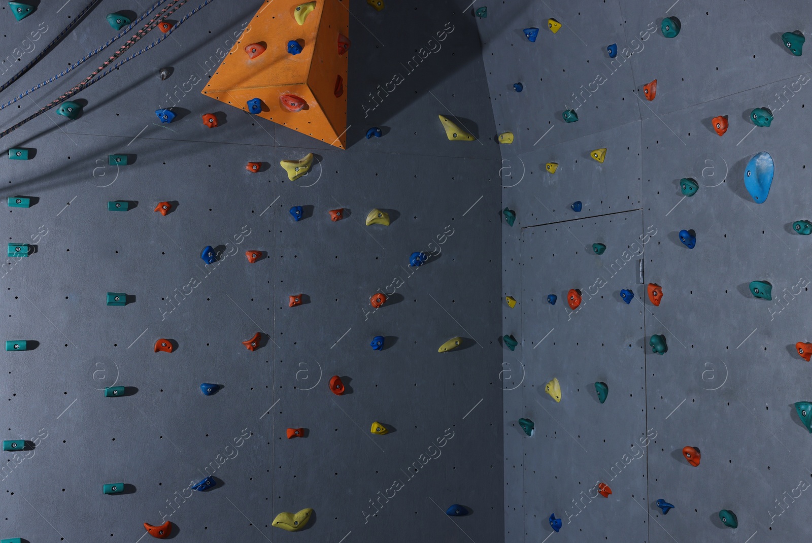 Photo of Climbing wall with holds in gym. Extreme sport