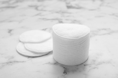 Photo of Stack of clean cotton pads on white marble table