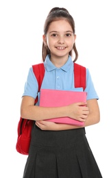 Cute little girl in school uniform with backpack and stationery on white background