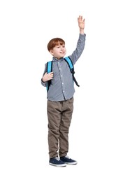 Photo of Smiling little boy with backpack waving hand on white background