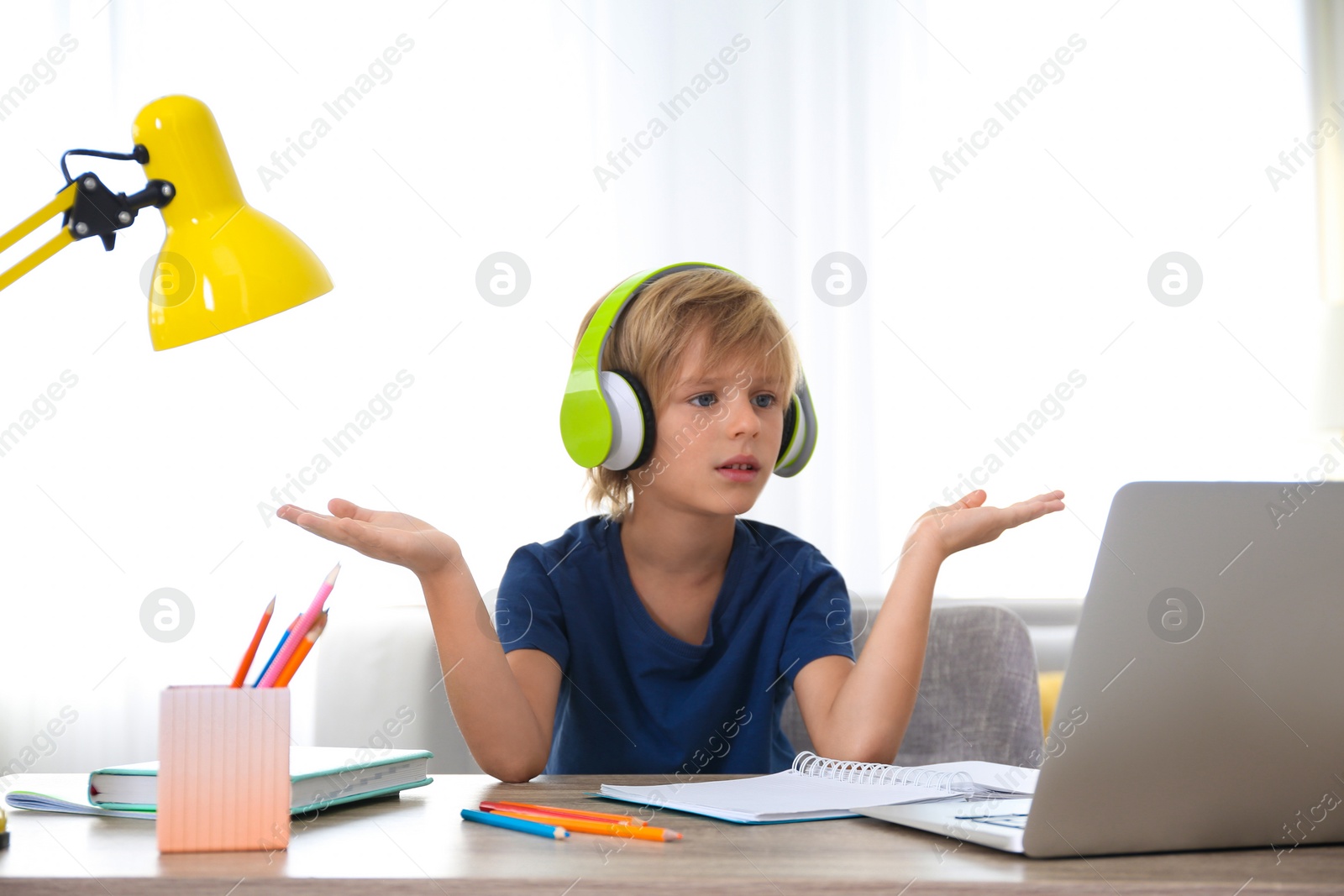 Photo of Little boy studying online at home. Distance learning during COVID-19 pandemic