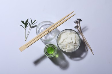 Photo of Ingredients for homemade candle on white background, top view