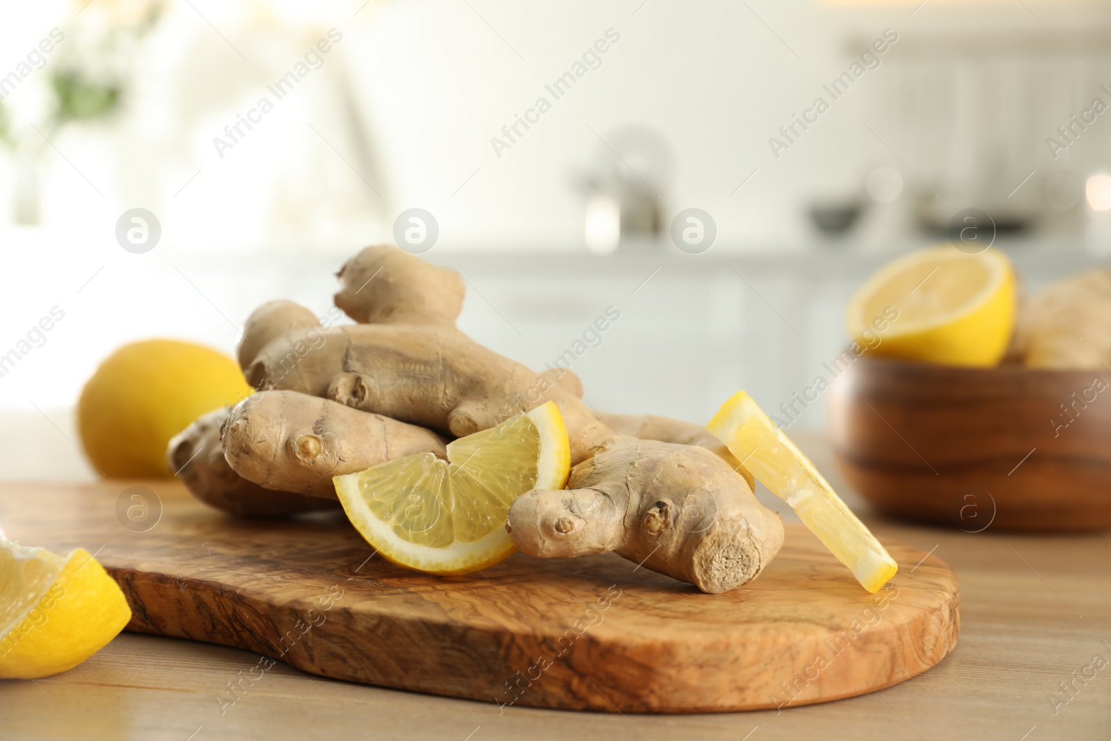 Photo of Fresh lemon and ginger on wooden table indoors