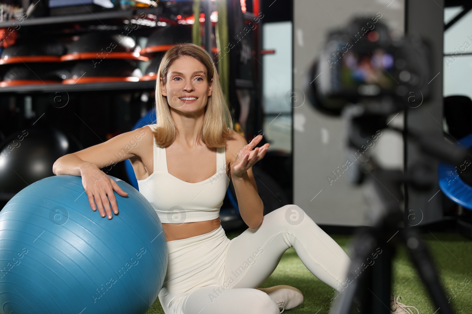 Photo of Fitness trainer recording online classes in gym